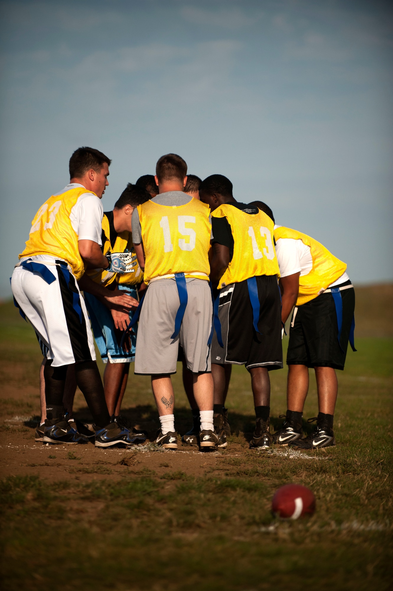SPANGDAHLEM AIR BASE, Germany – Members of the 52nd Aircraft Maintenance Squadron huddle up during a flag football game near the Skelton Memorial Fitness Center here Sept. 5.  The 52nd AMXS went on to win their first game of the season against the 52nd Logistics Readiness Squadron with a final score of 25-20.  The flag football season will continue until Oct. 31, thereafter the top eight teams will compete for the base championship title in a single elimination tournament. (U.S. Air Force photo by Airman 1st Class Gustavo Castillo/Released)
