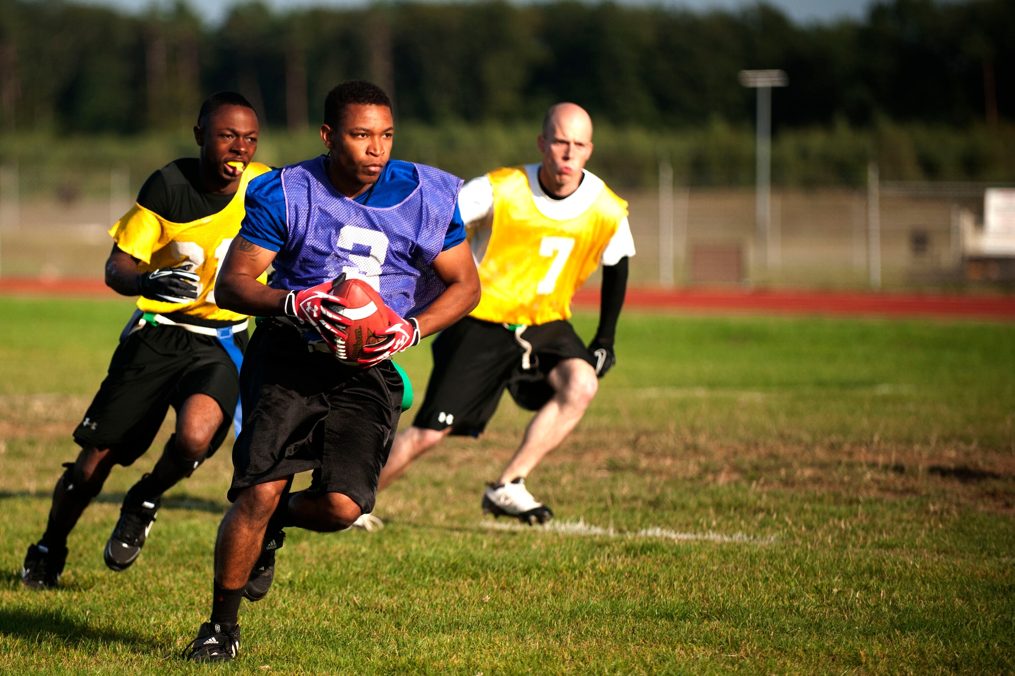 SPANGDAHLEM AIR BASE, Germany – Donnel Carney, 52nd Logistics Readiness Squadron unit deployment manager, runs down the field during a flag football game near the Skelton Memorial Fitness Center here Sept. 5.  Carney is the first-string quarterback for the 52nd LRS team and scored one touchdown during their first game of the season.  The flag football season will continue until Oct. 31, thereafter the top eight teams will compete for the base championship title in a single elimination tournament. (U.S. Air Force photo by Airman 1st Class Gustavo Castillo/Released)