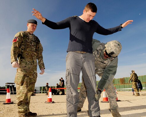 STANTA, Norfolk – On left, Corporal Michael O’Regan, No. 2 Tactical Police Squadron, RAF Henlow, provides security as Airman 1st Class Christopher Simmons, 100th Security Forces Squadron, RAF Mildenhall,  pats down Corporal Ashley Simpson, roleplaying as a insurgent, during a joint U.S. and Royal Air Force exercise Sept. 6, 2012, at Stanford Training Area, Thetford. Simpson played an insurgent during the exercise to provide a realistic training scenario for both the U.S. and RAF Airmen. (U.S. Air Force photo/Senior Airman Ethan Morgan)