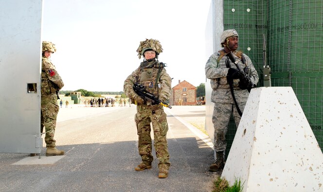 STANTA, Norfolk – Center, Corporal Katie Vanderwoning, Tactical Police Squadron, RAF Henlow, and Staff Sgt. Michael Denson, 100th Security Forces Squadron, RAF Mildenhall, stand guard at an entry control point during a joint U.S. and Royal Air Force exercise Sept. 6, 2012, at Stanford Training Area, Thetford. The exercise simulated a raid on a third country national encampment where it was believed that enemy forces were making improvised explosive devices. (U.S. Air Force photo/Senior Airman Ethan Morgan)