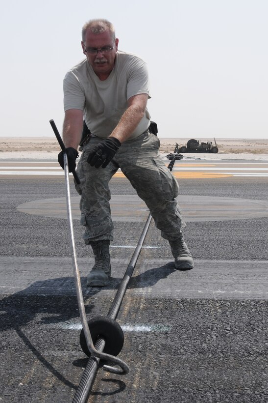 SOUTHWEST ASIA -- U.S. Air Force Master Sgt. Robert Marshall, 380th Expeditionary Civil Engineer Squadron Barrier Maintenance NCO in charge, spaces cable support discs on the mobile aircraft arresting system here Sept. 5, 2012. Marshall, a Lockport, N.Y., native is deployed from Niagara Falls Air Reserve Station, N.Y. (U.S. Air Force photo/Tech. Sgt. Amanda Savannah)