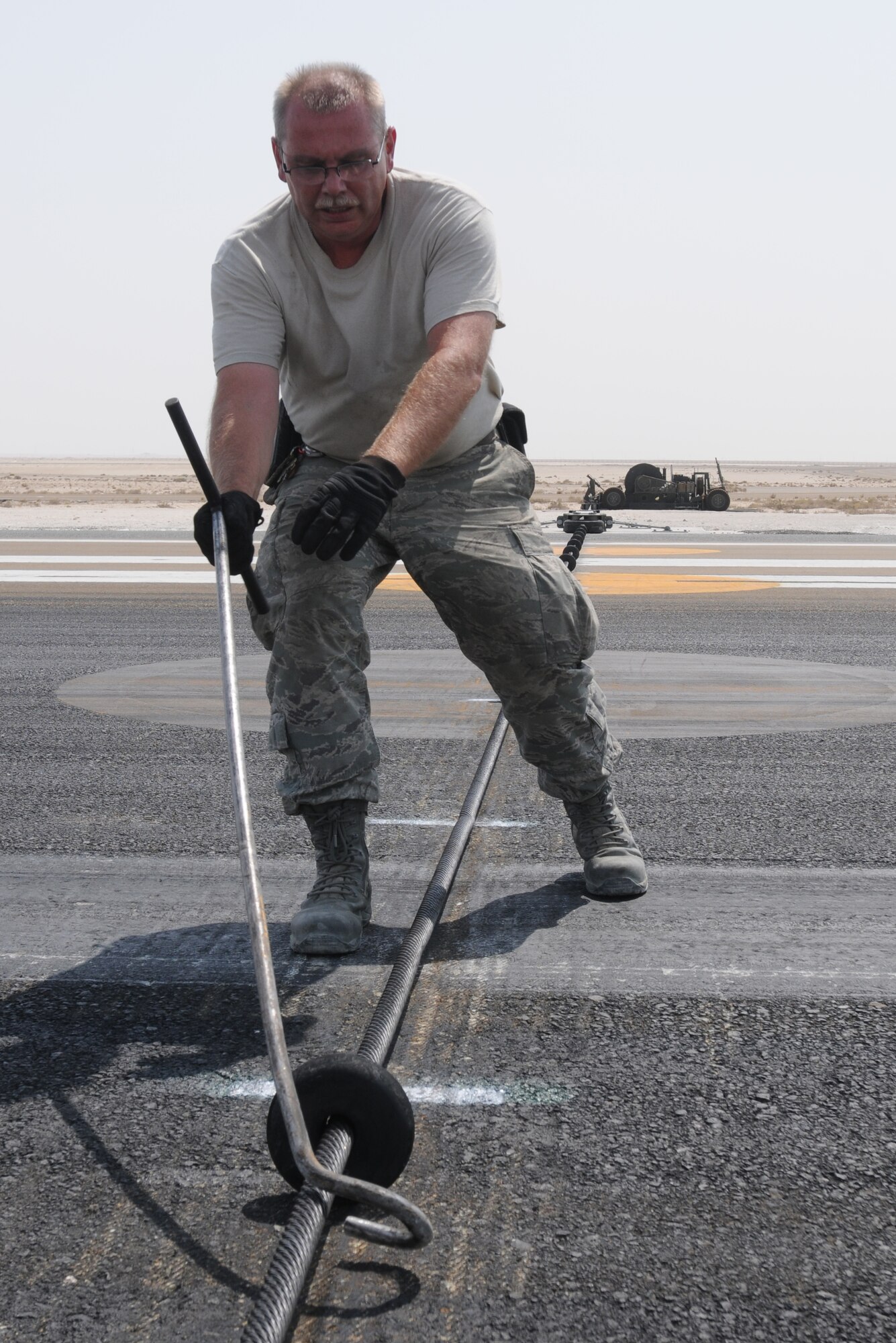 SOUTHWEST ASIA -- U.S. Air Force Master Sgt. Robert Marshall, 380th Expeditionary Civil Engineer Squadron Barrier Maintenance NCO in charge, spaces cable support discs on the mobile aircraft arresting system here Sept. 5, 2012. Marshall, a Lockport, N.Y., native is deployed from Niagara Falls Air Reserve Station, N.Y. (U.S. Air Force photo/Tech. Sgt. Amanda Savannah)