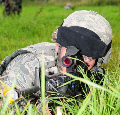 STANTA, Norfolk – An Airman from the 100th Security Forces Squadron, RAF Mildenhall, keeps an eye out for the enemy after he and the rest of his team were ambushed during a route-clearance mission as part of an exercise at Stanford Training Area, Thetford, Sept. 4, 2012. In addition to doing their own training, the 100th SFS personnel spent several days at STANTA playing the role of the U.S. Marine Corps with Royal Air Force members from three squadrons, who are finishing the final stage of year-long preparation for deployment to Afghanistan. (U.S. Air Force photo/Karen Abeyasekere)