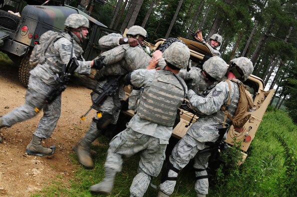 STANTA, Norfolk – Members from the 100th Security Forces Squadron scramble to help wounded members of their team after they come under ambush during a training exercise at Stanford Training Area, Thetford, Sept. 4, 2012. In addition to doing their own training, the 100th SFS personnel spent several days at STANTA role-playing as the U.S. Marine Corps with Royal Air Force members from three squadrons, who are finishing the final stage of year-long preparation for deployment to Afghanistan. (U.S. Air Force photo/Karen Abeyasekere)