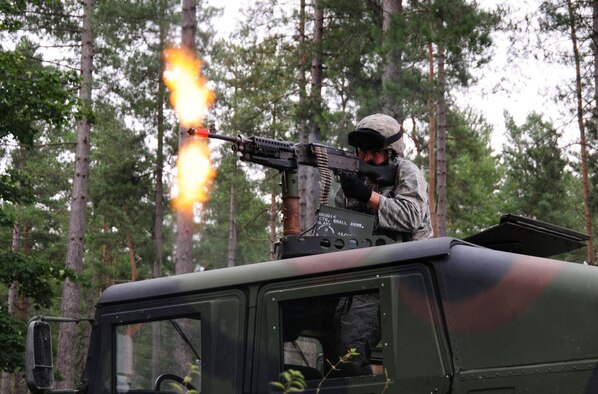 STANTA, Norfolk – A 100th Security Forces Squadron Airman fires from a HUMVEE during an ambush as part of an exercise at Stanford Training Area, Thetford, Sept. 4, 2012. Forty U.S. Air Force personnel took part in scenarios including weapons cache sweeps. Two military working dogs also alongside Royal Air Force members during a mission rehearsal exercise lasting several days. During the joint exercise they role-played as the U.S. Marine Corps, which the RAF members will be working with during an upcoming deployment to Afghanistan. The 100th SFS also conducted their own training throughout the exercise, such as simulating an ambush. (U.S. Air Force photo/Karen Abeyasekere)