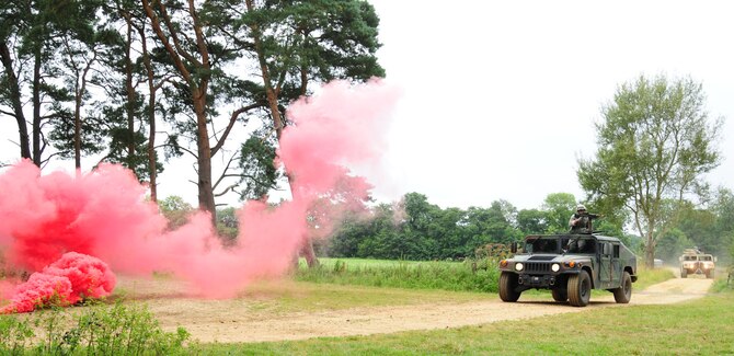 STANTA,  Norfolk – U.S. Airmen from the 100th Security Forces Squadron encounter smoke grenades simulating an improvised explosive device as they travel “home” in their HUMVEEs, before coming under ambush during an exercise at Stanford Training Area, Thetford, Sept. 4, 2012. The RAF Mildenhall personnel were at STANTA for several days, working alongside British Royal Air Force members, assisting them with a mission rehearsal exercise. The RAF squadrons are preparing to deploy to Afghanistan, and the STANTA exercise was the final stage in year-long preparation for their deployment. (U.S. Air Force photo/Karen Abeyasekere)