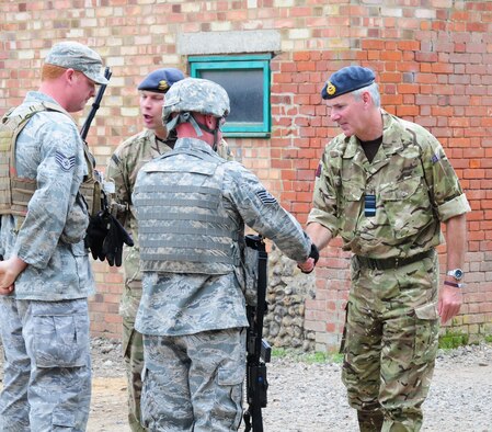STANTA, Norfolk – Air Marshall Andrew Pulford, right, Deputy Commander Capability/Air Member for Personnel and Capability, High Wycombe, meets with Tech. Sgt. Curtis Webb and Staff Sgt. Jonathan Williams, 100th Security Forces Squadron, during a mission rehearsal exercise at Stanford Training Area, Thetford, Sept. 4, 2012. The air marshall visited British and American military members at STANTA as they worked side-by-side during a joint exercise. (U.S. Air Force photo/Karen Abeyasekere)