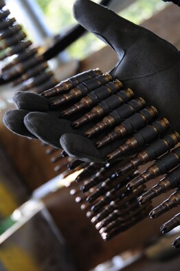 STANTA, Norfolk – A 100th Security Forces Squadron Airman holds a belt of simulated rounds for the M240B machine gun while on duty at the Guardian 1 tower, Stanford Training Area, Thetford, Sept. 4, 2012. Members from the 100th SFS spent several days with British Royal Air Force troops during a mission rehearsal exercise. The exercise was the final part of year-long training for the British forces, before they deploy to Afghanistan. (U.S. Air Force photo/Karen Abeyasekere)