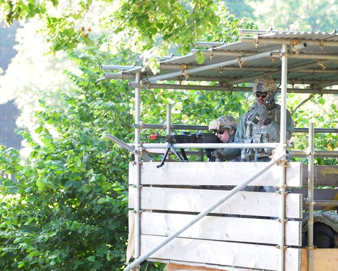 STANTA, Norfolk – Airmen 1st Class Joseph Kline (left) and Christopher Simmons, 100th Security Forces Squadron gunners, provide security of incoming traffic for “Forward Operating Base Oakwood” at Guardian 1, Stanford Training Area, Thetford, Sept. 4, 2012. Members from the 100th SFS manned several towers around the FOB during a joint mission rehearsal exercise, also known as MRX,with Royal Air Force members from 15 Squadron, RAF Honington; No. 2 Tactical Police Squadron, RAF Henlow; and No. 7 Force Protection Wing Headquarters, RAF Coningsby. During the MRX, U.S. Air Force members played as U.S. Marine Corps for the British forces, who are scheduled to deploy to Afghanistan in the near future. (U.S. Air Force photo/Karen Abeyasekere)