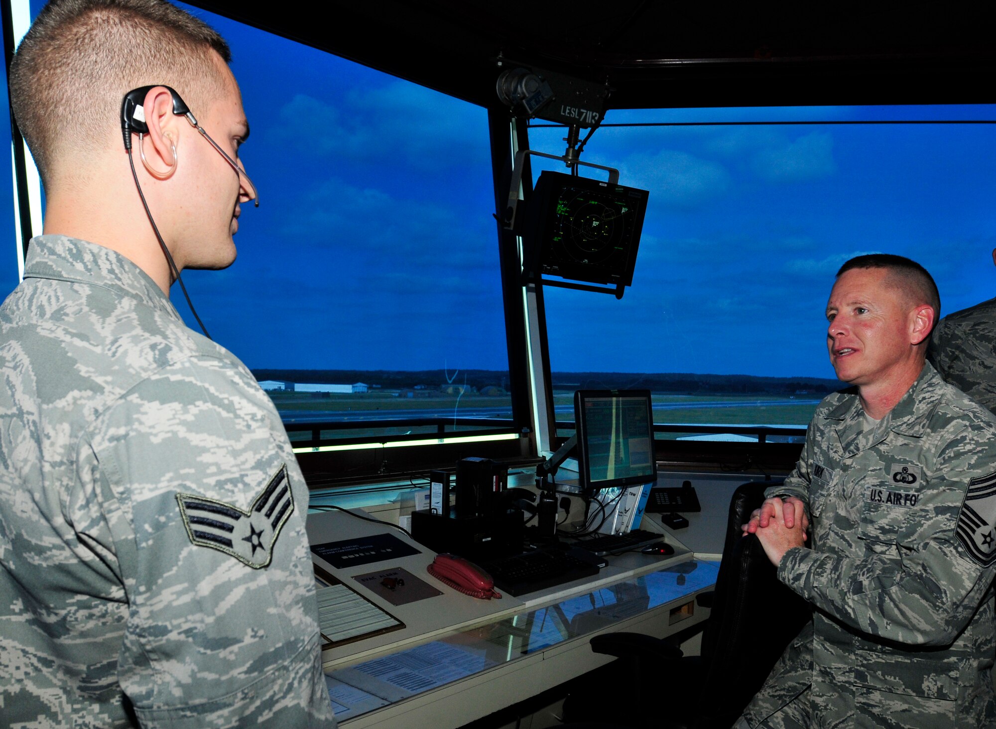 ROYAL AIR FORCE LAKENHEATH, England - Chief Master Sgt. Joseph Kirk, Air Traffic Control career field manager Headquarters U.S. Air Force, Washington, D.C., right, speaks with Senior Airman Brandon Boncore, 48th Operation Support Squadron air traffic controller, in the ATC tower Sept. 5, 2012. Kirk visited the 48th Fighter Wing as his first stop during his U.S. Air Forces in Europe tour. (U.S. Air Force photo by Senior Airman Tiffany M. Grigg)