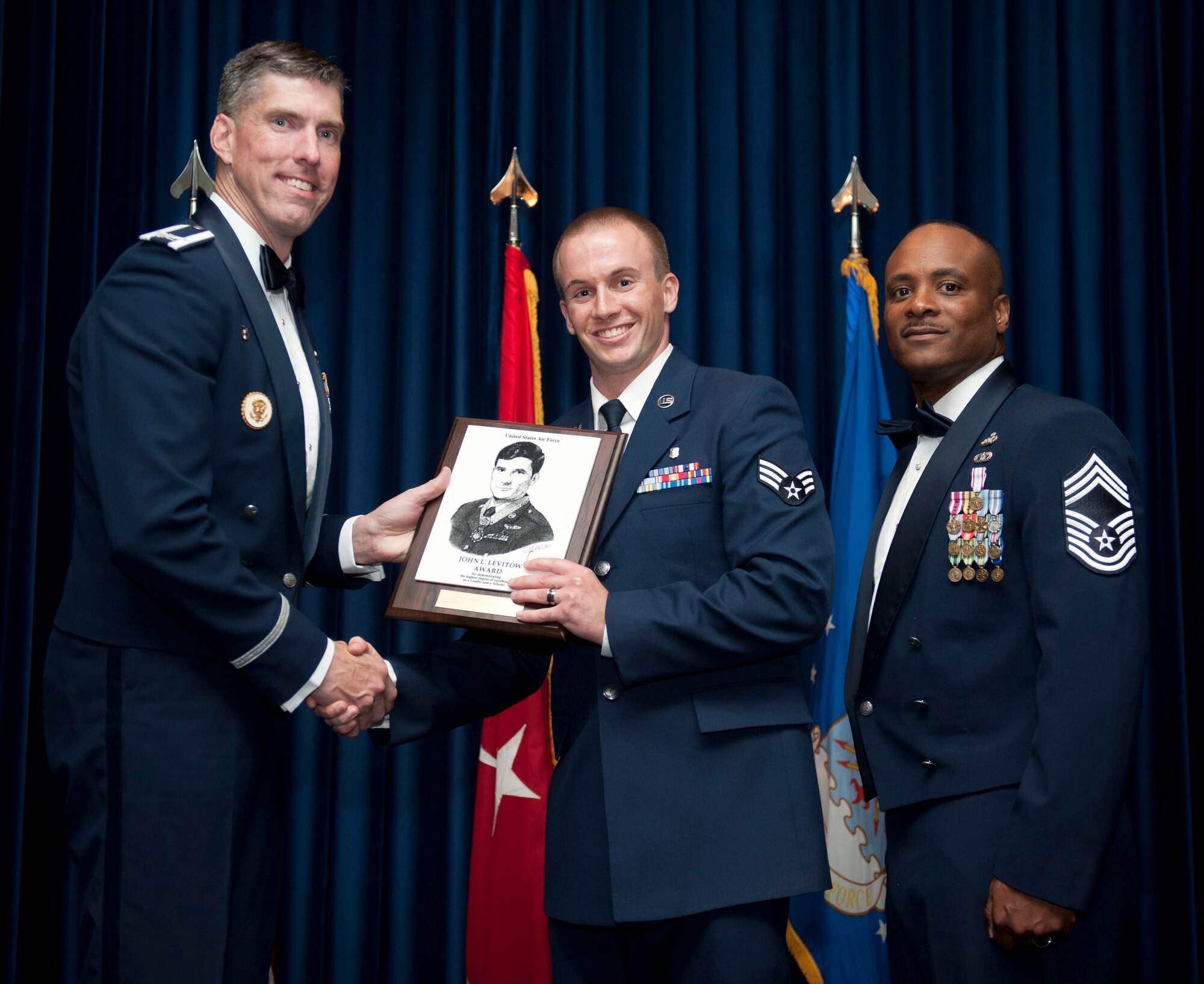 Senior Airman Christopher Wright, 39th Medical Operations Squadron public health technician, receives the John L. Levitow Award from Col. Chris Craige, 39th Air Base Wing commander, during the Class 12-F graduation Sep. 6, 2012, at Incirlik Air Base, Turkey. The Levitow Award is the highest achievement for enlisted Airmen enrolled in U.S. Air Force professional military education. There are four levels of PME: ALS, NCO Academy, Air Force Senior NCO Academy and Chief Master Sergeant Leadership Course. (U.S. Air Force photo by Senior Airman Clayton Lenhardt/Released)