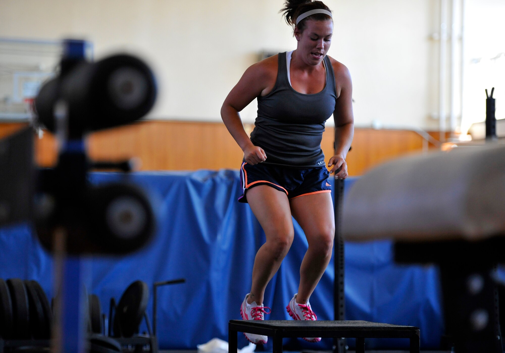 Korinne Hoh, Warrior Fit class participant, jumps onto a box while completing the box jumps and burpees portion of the exercise class at Misawa Air Base, Japan, Sept. 7, 2012. Warrior Fit is a class offered by the Potter Fitness Center that gives participants a full-body workout and is free for all base members. (U.S. Air Force photo by Airman 1st Class Zachary Kee/Released)