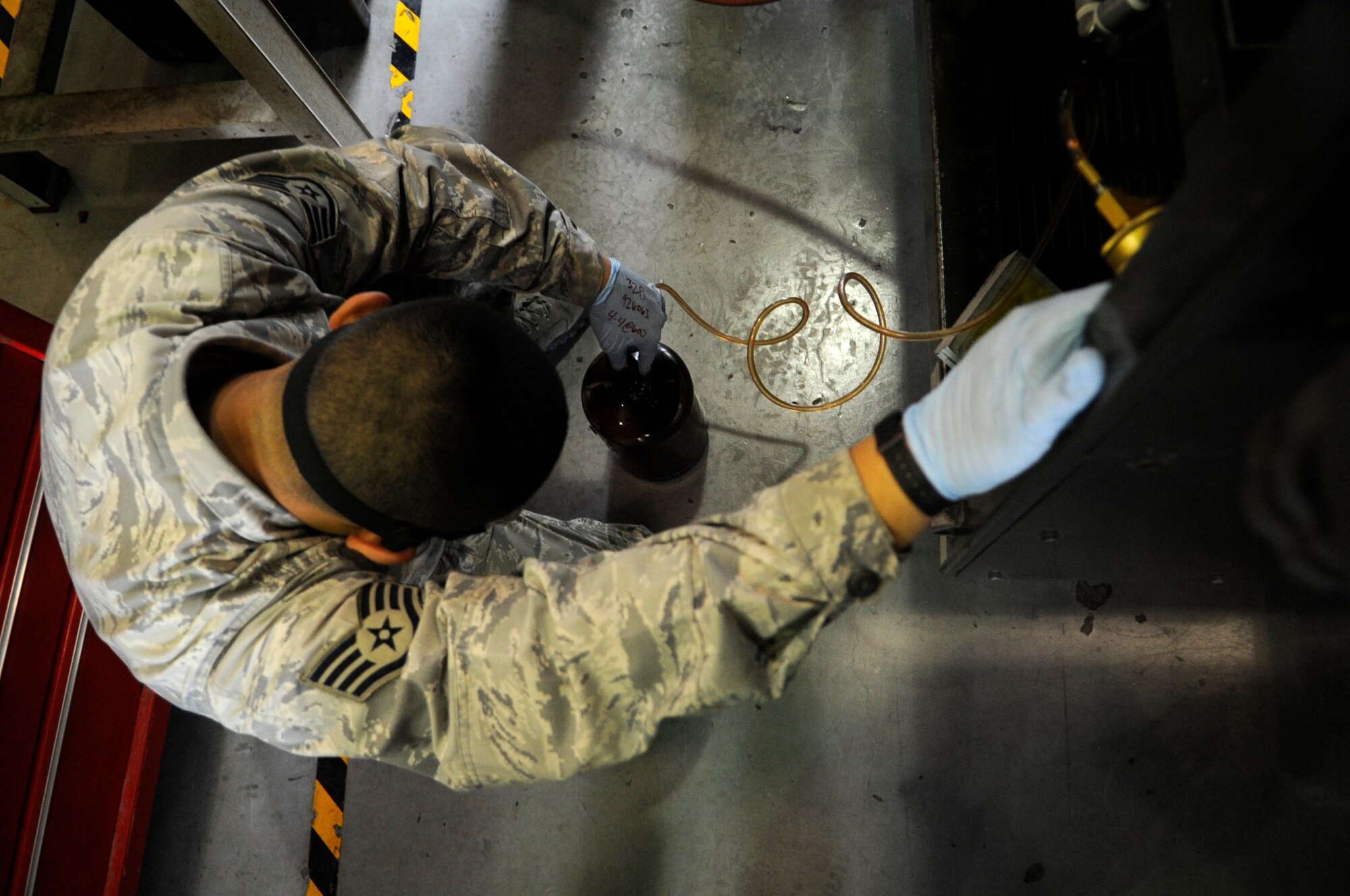 Staff Sgt. Benny Cruz, 8th Logistics Readiness Squadron fuels lab NCO in charge, fills a jug with fuel from a truck at Kunsan Air Base, Republic of Korea, Sept. 4, 2012. The fuel is tested for many things from water to contaminants to make sure it will work putting F-16 Fighting Falcons in the air. (U.S. Air Force photo/Senior Airman Brigitte N. Brantley)