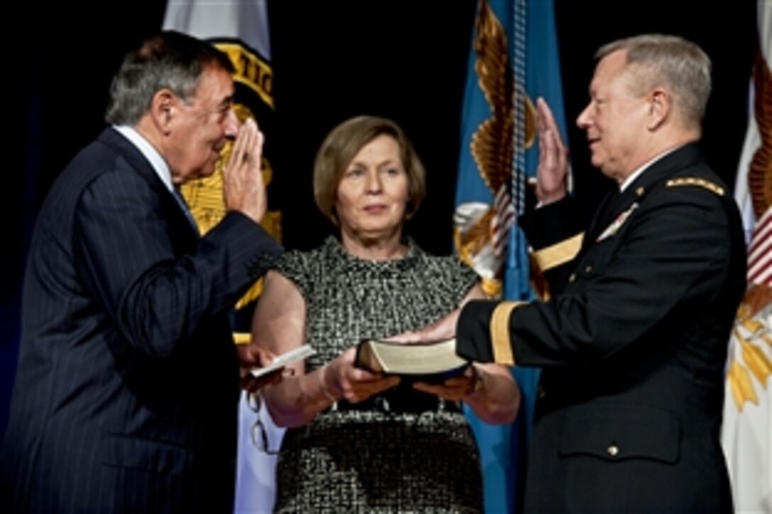 Defense Secretary Leon E. Panetta swears in Army Lt. Gen. Frank J. Grass as National Guard Bureau chief during the change-of-responsibility ceremony for chief at the Pentagon, Sept. 7, 2012. Grass, who received his fourth star during the event, replaced Air Force Gen. Craig R. McKinley.