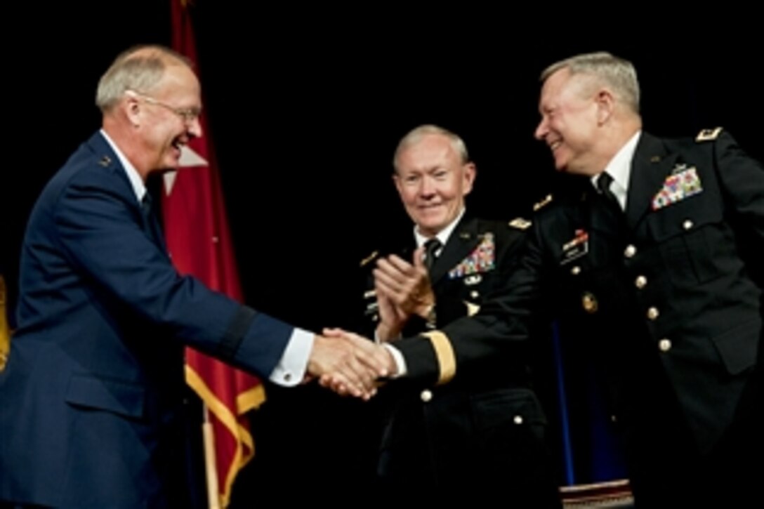 Army Gen. Martin E. Dempsey, center, chairman of the Joint Chiefs of Staff, applauds as Air Force Gen. Craig R. McKinley, left, outgoing National Guard Bureau chief, shakes hands with Army Lt. Gen. Frank J. Grass, incoming chief, during the change-of-responsibility ceremony for chief at the Pentagon, Sept. 7, 2012. Grass received his fourth star during the event.