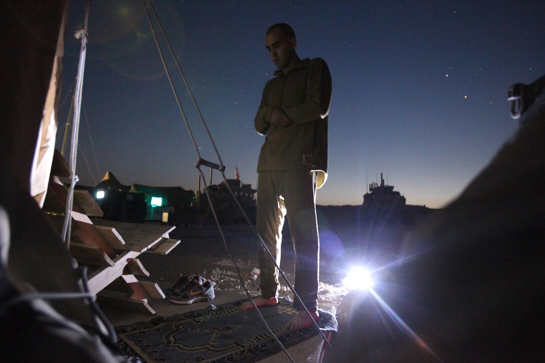 Lance Cpl. Malike Mejdouli prays during the early morning of the last day of Ramadan at Combat Outpost Pennsylvania, August 19, 2012. Mejdouli, a devout Muslim, is a radio operator with Bravo Company, 1st Battalion, 1st Marines, Regimental Combat Team 6.