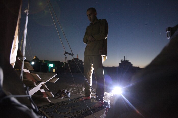 Lance Cpl. Malike Mejdouli prays during the early morning of the last day of Ramadan at Combat Outpost Pennsylvania, August 19, 2012. Mejdouli, a devout Muslim, is a radio operator with Bravo Company, 1st Battalion, 1st Marines, Regimental Combat Team 6.