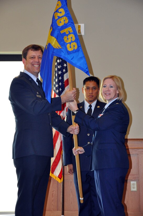 (Right) Lt. Col. Connie Alge receives the guideon from Col. John Breeden, 926th Group Commander, upon assuming command of the 926th Force Support Squadron during a ceremony here Sept. 7. (U.S. Air Force photo/Tech. Sgt. Angela McGuire)