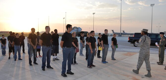A new day dawns as 26 trainees comprise the first class of the 433rd Airlift Wing's Delayed Entry Training Flight under the direction of Tech. Sgt. David Gaffney, 433rd Airlift Wing Military Training Leader, and Airman First Class Ryan King (right) on Sept 8 at Joint Base San Antoino-Lackland, Texas.   (U.S. Air Force photo/Tech. Sgt. Carlos J. Trevino)