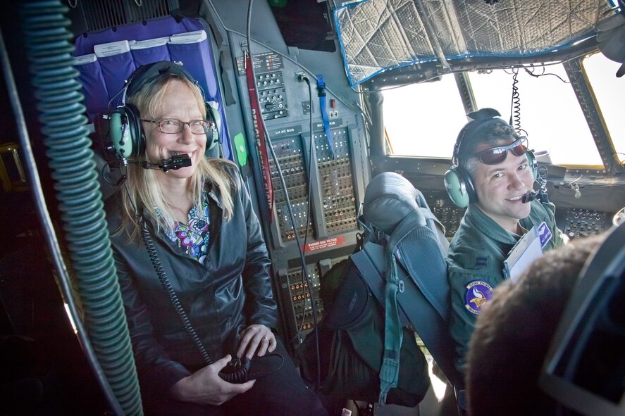 Suzanne Asher, who works with Veterans in the Arts, gets a view from the flight deck and a description of operations from Capt. Matt Crawford enroute back to Minneapolis from Joint Base Charleston, SC.  Civic leaders from the Minneapolis area traveled with the 934th Airlift Wing and were hosted by the 315th Airlift Wing in Charleston during a two day tour to learn more about the Air Force.  (U. S. Air Force Photo/Shannon McKay)