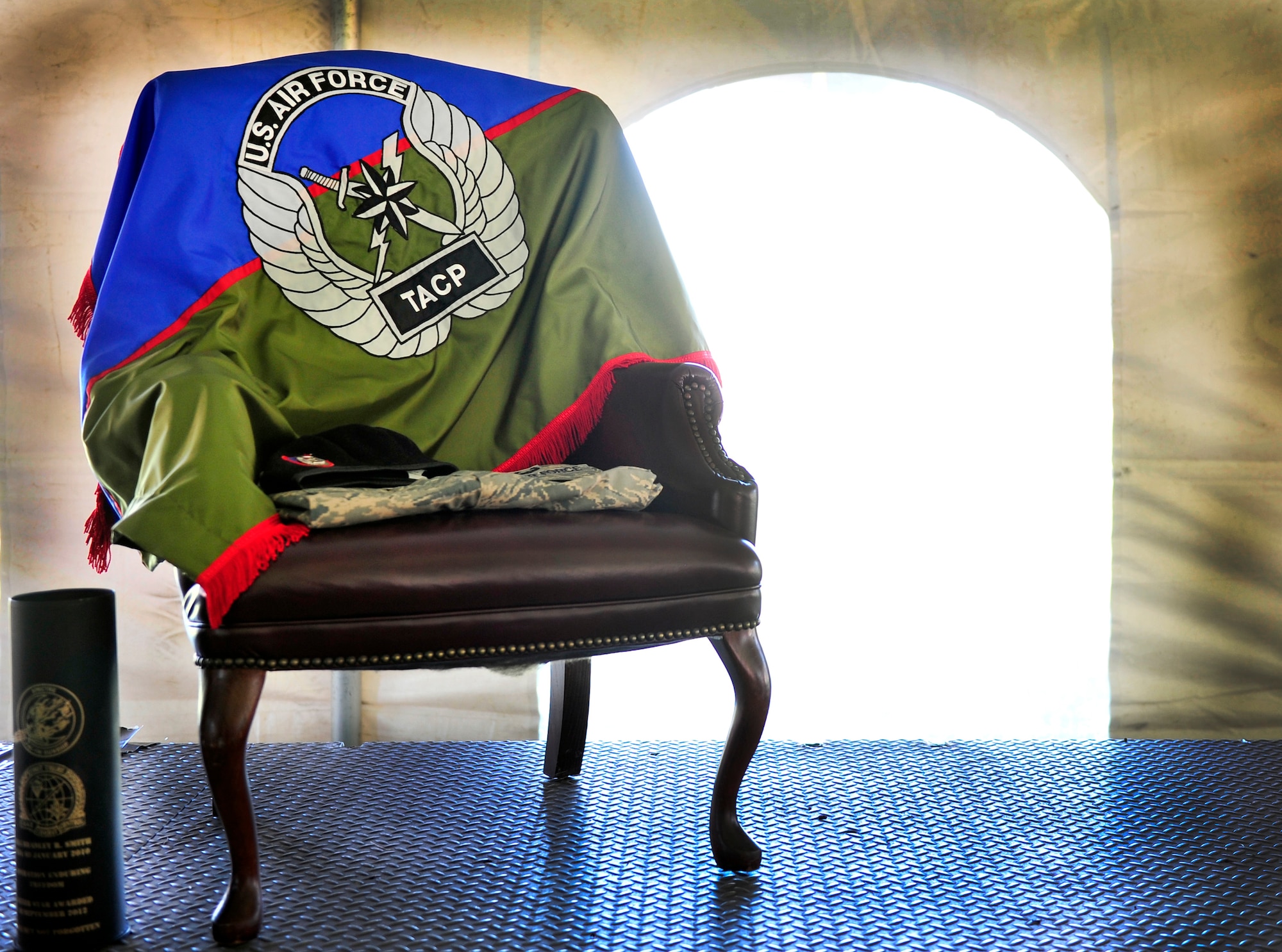 A stand alone chair, decorated with a flag from Senior Airman Bradley Smith’s unit and his uniform, symbolizes his absence during a Silver Star ceremony in Troy, Ill., Sept. 8, 2012. (U.S. Air Force photo/ Staff Sgt. Stephenie Wade)