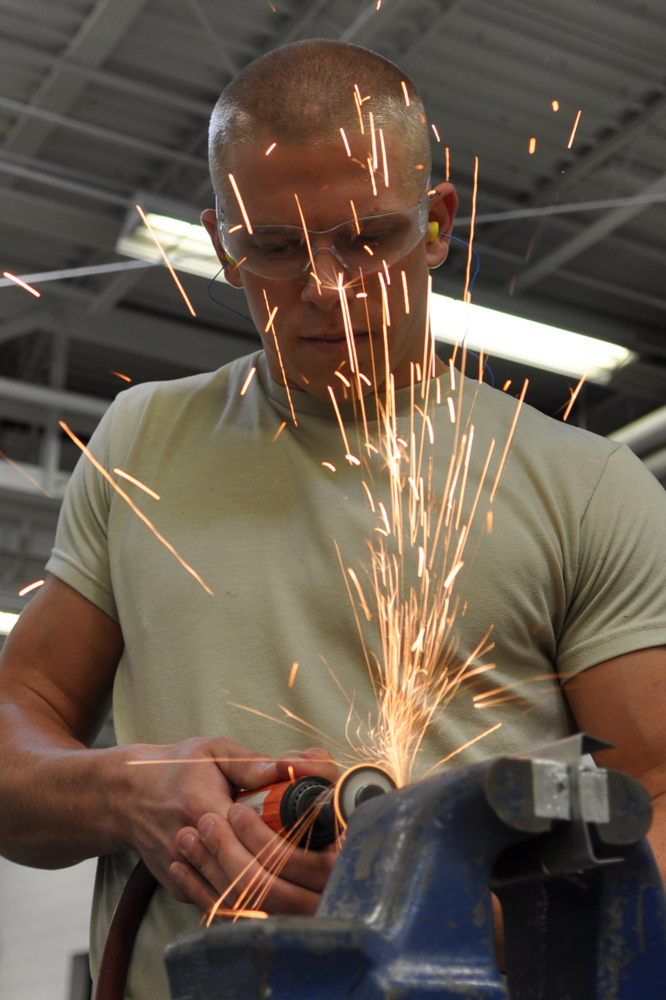 Senior Airman Hayden Johnson, a structural maintenance craftsman assigned to the 307th Maintenance Squadron, Barksdale Air Force Base, La., cuts a piece of metal with a grinding wheel at Minot Air Force Base, N.D., Sept. 5, 2012. He was one of 42 Airmen from Barksdale who deployed to Minot in support of NORTHERN BREAK. (U.S. Air Force photo by Master Sgt. Jeff Walston/Released)