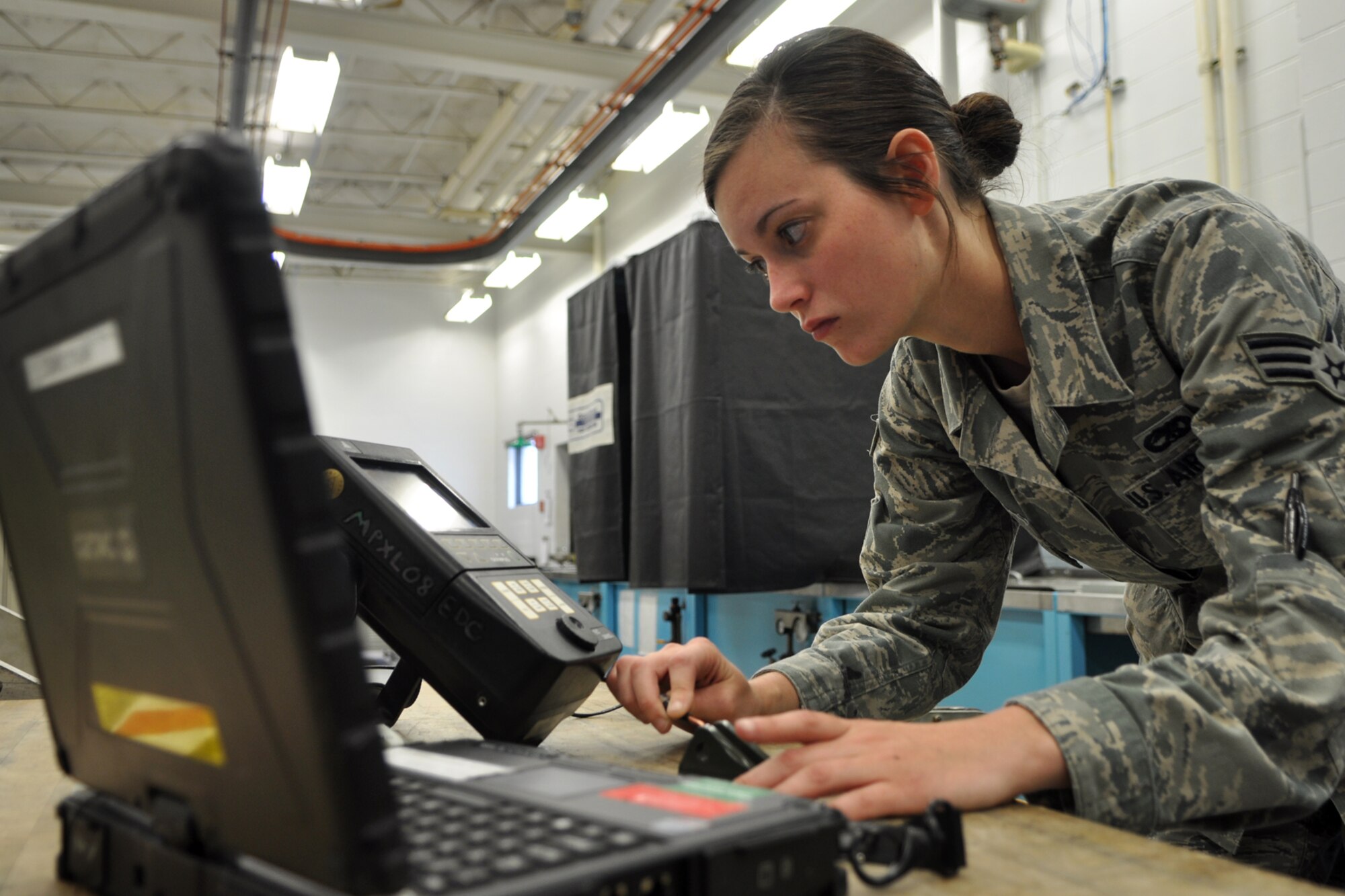 Senior Airman Cassi Heyl, a nondestructive inspection technician, assigned to the 307th Maintenance Squadron, performs an Eddy Current inspection on a bracket at Minot Air Force Base, N.D., Sept. 5, 2012. Heyl was looking for cracks in the bracket. She was one of 42 Airmen from Barksdale who deployed to Minot in support of NORTHERN BREAK. (U.S. Air Force photo by Master Sgt. Jeff Walston/Released)