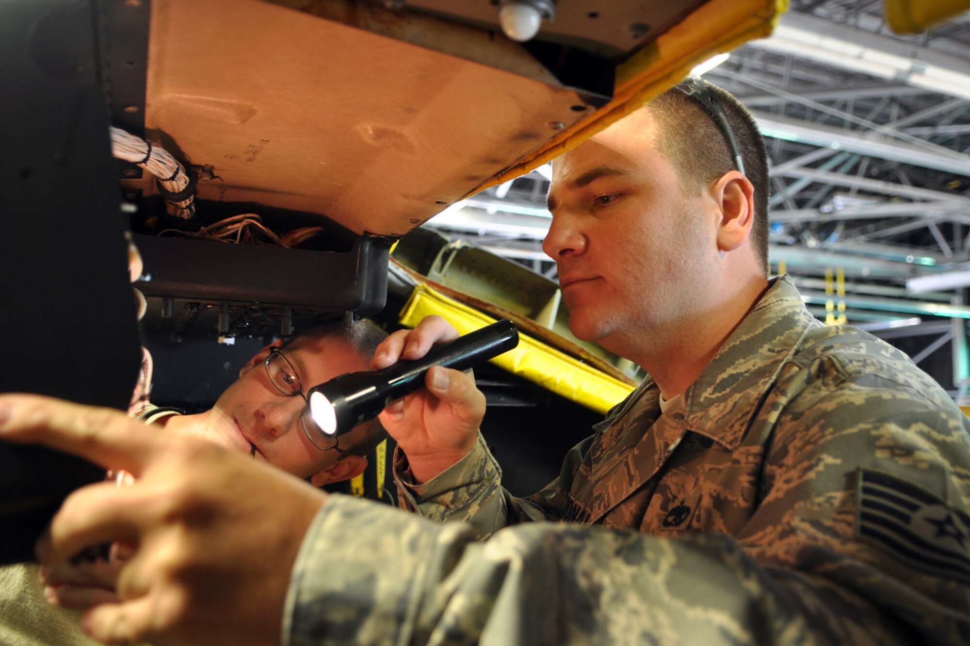 Tech. Sgt. Jared McDonald, 307th Maintenance Squadron, prepares to replace a circuit breaker guard on a B-52 Stratofortress with the assistance of Staff Sgt. Brandon Patterson, 5th Maintenance Squadron, at Minot, Air Force Base, La., Sept. 4, 2012. Both Airmen are electronic countermeasures technicians. (U.S. Air Force photo by Master Sgt. Jeff Walston/Released)