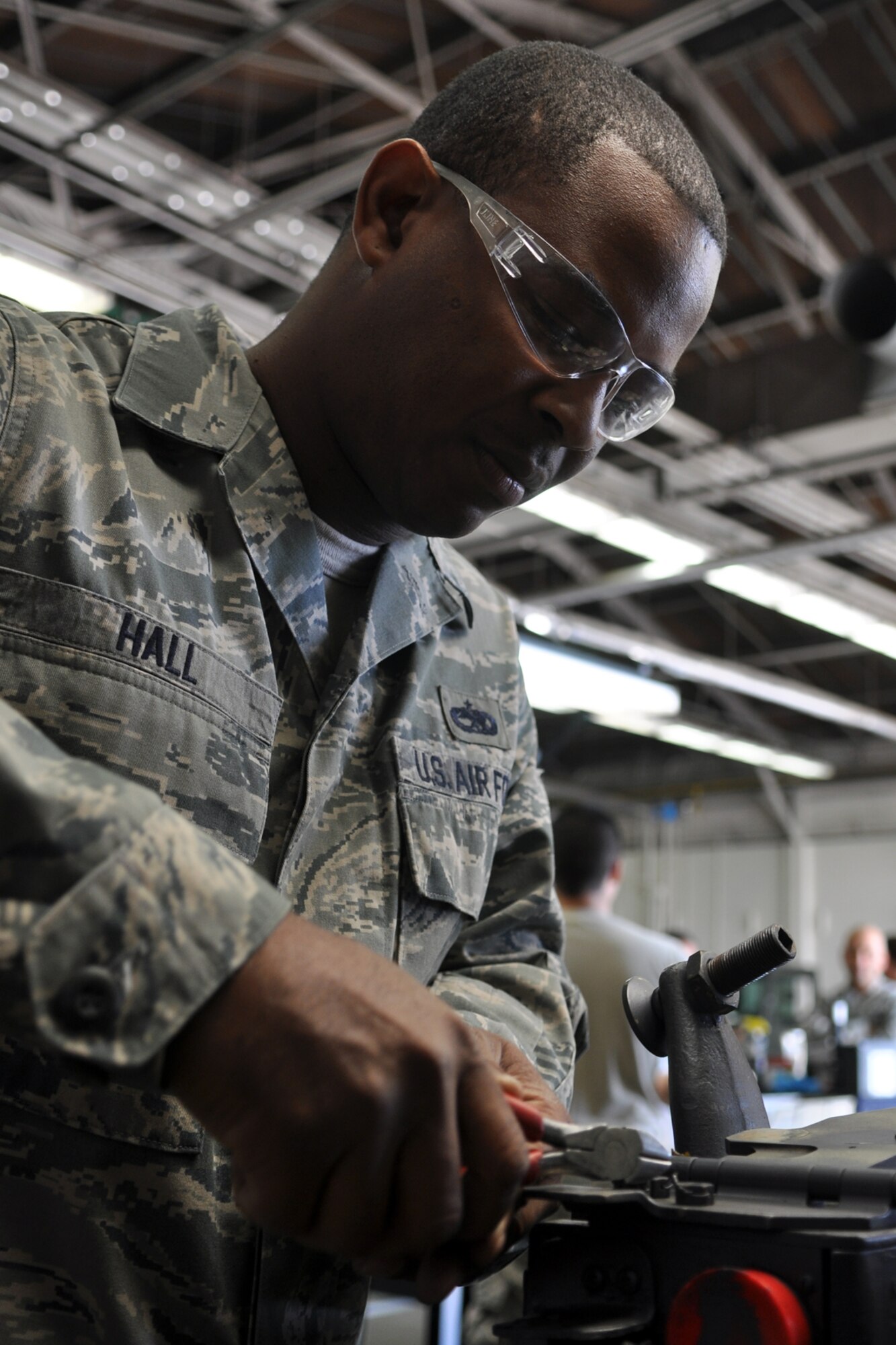 Staff Sgt. Quincy Hall, an armament systems technician assigned to the 307th Maintenance Squadron, Barksdale Air Force Base, La., disassembles the face plate of a MAU-12 bomb rack for a B-52 Stratofortress at Minot Air Force Base, N.D., Sept. 4, 2102. Hall was one of 42 Airmen from Barksdale who deployed to Minot in support of NORTHERN BREAK. (U.S. Air Force photo by Master Sgt. Jeff Walston/Released)