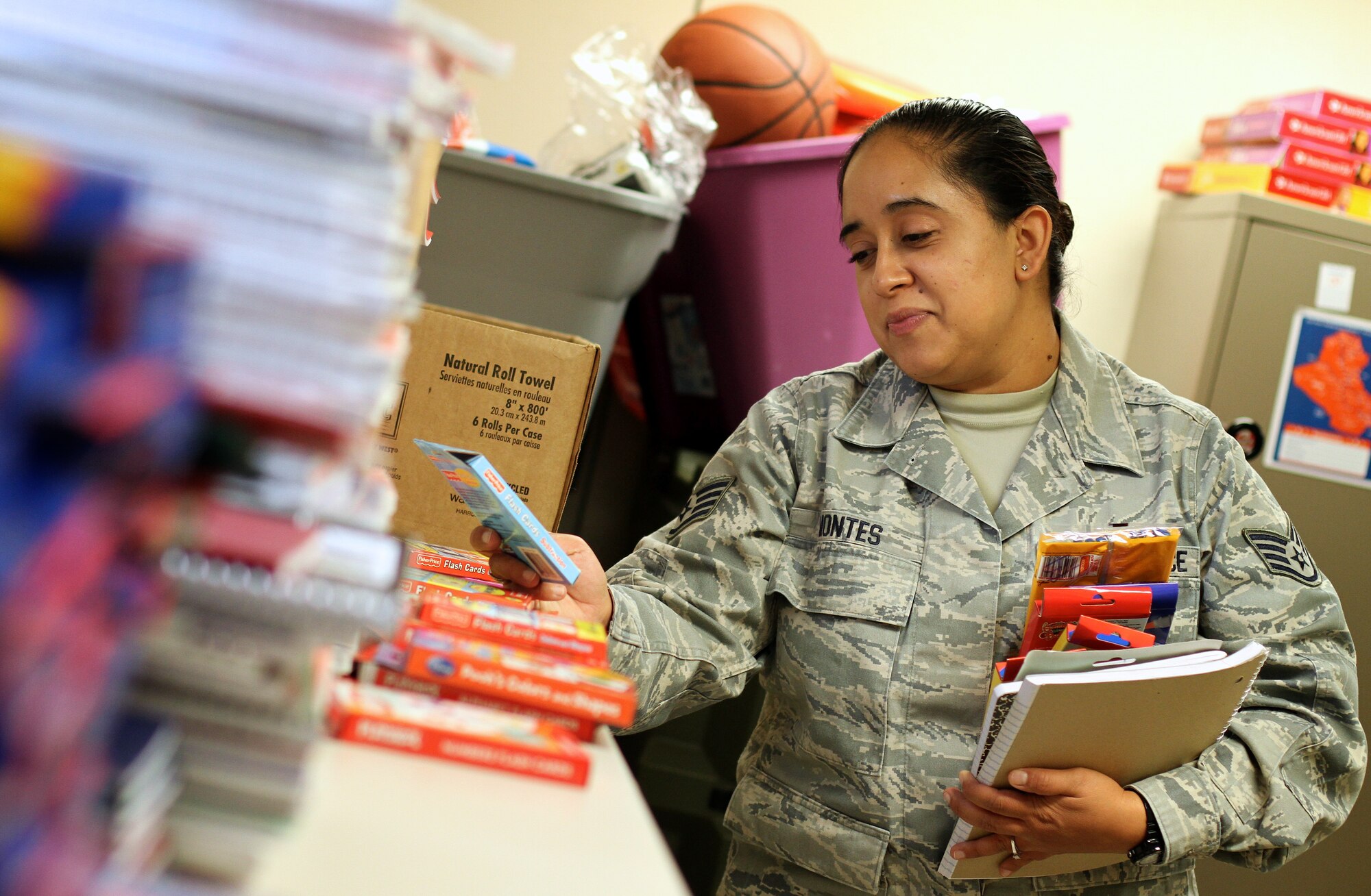 Staff Sgt. Francisca Montes, Non-Commisioned Officer in Charge, Personnel Readiness, looks over the donated school supplies in the 932nd Airlift Wing Family Readiness office.  Montes was picking up suppplies for her children.  (U.S. Air Force photo/Tech. Sgt. Christopher Parr)