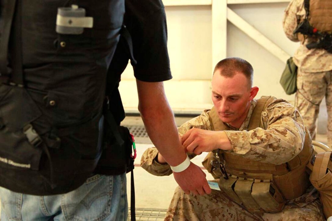 Sergeant Kyle J. Schultz, squad leader, Transportation Detachment, Combat Logistics Battalion 15, 15th Marine Expeditionary Unit, clears an American citizen for transportation to the safe haven during a non-combatant evacuation operation exercise at Marine Corps Air Station Camp Pendleton, Calif., Aug. 20. The 15th MEU was conducting the training as part of Certification Exercise, their final pre-deployment training. CERTEX is different than previous exercises because Marines and Sailors do not know the training scenario in advance. They have to react quickly using the Marine Corpsâ€™ Rapid Response Planning Process, which is the process leaders use to prepare for missions the unit will execute.