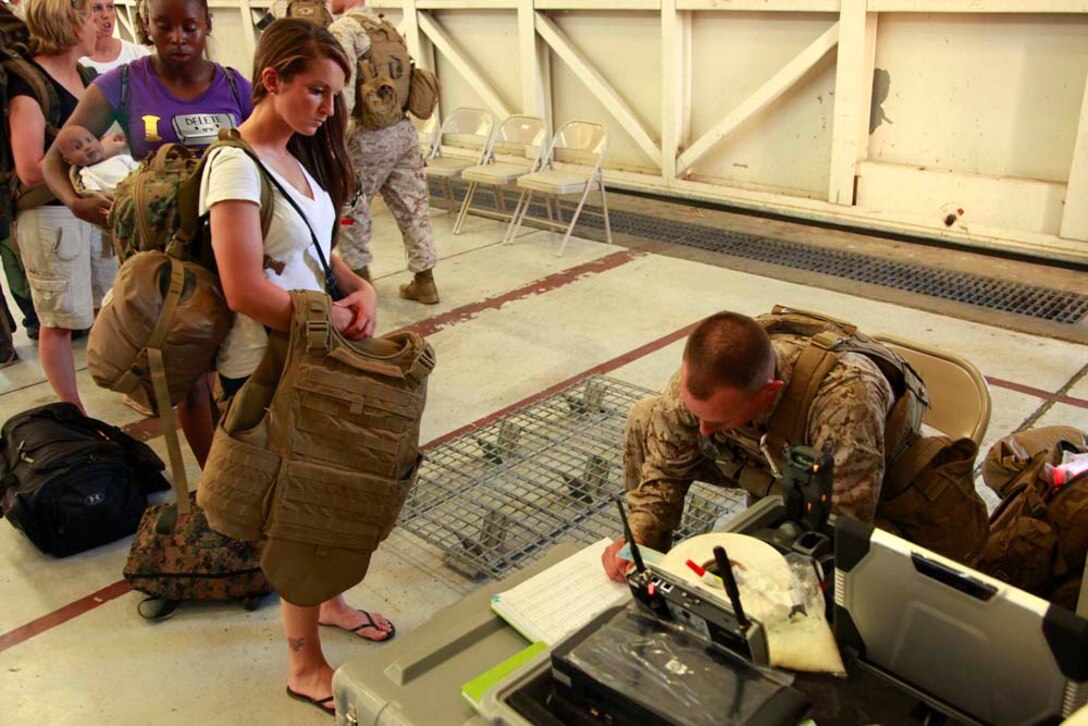 Sergeant Kyle J. Schultz, squad leader, Transportation Detachment, Combat Logistics Battalion 15, 15th Marine Expeditionary Unit, clears a role player simulating an employee for the United States Agency for International Development for transportation to the safe haven, during a non-combatant evacuation operation exercise, at Marine Corps Air Station Camp Pendleton, Calif., Aug. 20. The 15th MEU was conducting the training as part of Certification Exercise, their final pre-deployment training. CERTEX is different than previous exercises because Marines and Sailors do not know the training scenario in advance. They have to react quickly using the Marine Corpsâ€™ Rapid Response Planning Process, which is the process leaders use to prepare for missions the unit will execute.