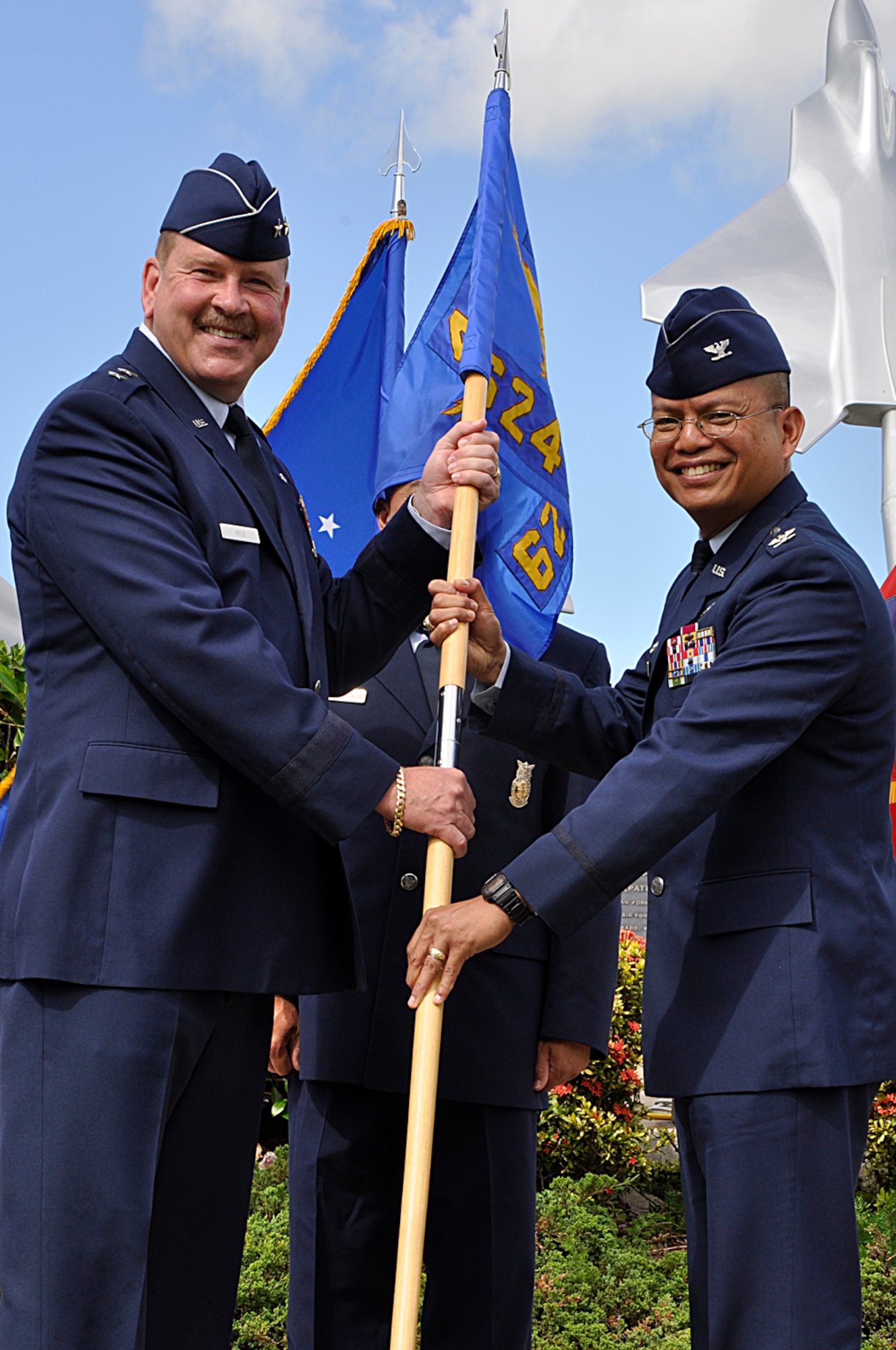 JOINT BASE PEARL HARBOR-HICKAM, Hawaii -- Col. Maynard “Max” Mendoza receives the group guidon from Maj. Gen. Mark Kyle, 4th Air Force commander, thus assuming command of the 624th Regional Support Group during a ceremony held Sept. 8 at the Missing Man Formation, Aloha Aina Park, here. Colonel Mendoza is now responsible for managing the largest Air Force Reserve presence in the Pacific, which is comprised of six units in Hawaii and Guam. The group provides combatant commanders more than 650 combat-ready Airmen who specialize in aerial port, aeromedical staging, civil engineering and security forces operations for worldwide deployment. (Air Force photo by Master Sgt. Daniel Nathaniel III)