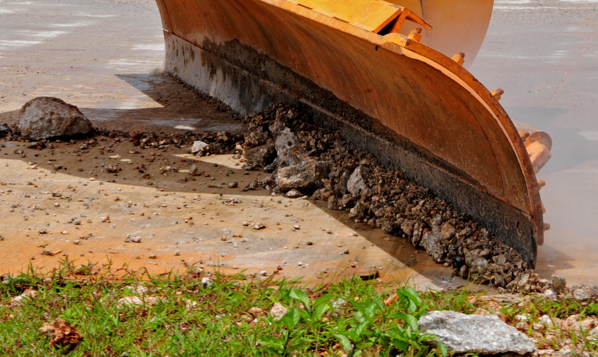 ANDERSEN AIR FORCE BASE, Guam – The dozer blade scrapes off debris around the crater during the 36th Civil Engineer Squadron airfield damage repair training at Northwest Field here, Aug. 30. The airfield damage repair team employs both manual labor and heavy machinery to remove debris away from damaged area. (U.S. Air Force photo by Airman 1st Class Marianique Santos/Released)