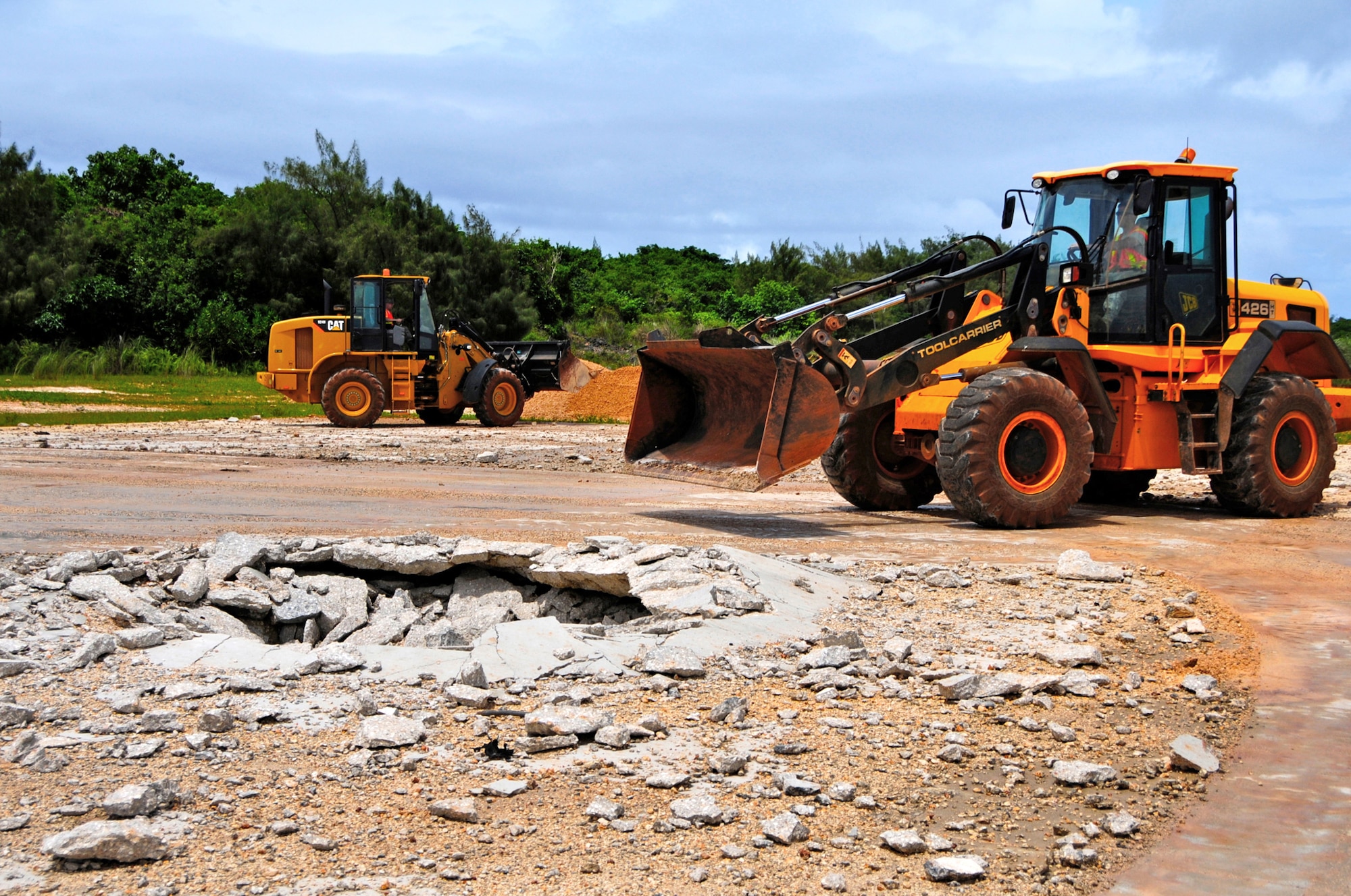 ANDERSEN AIR FORCE BASE, Guam -- 36th Civil Engineer Squadron airfield damage repair team utilizes loaders in fixing a simulated missile attack on an airfield at Northwest Field here, Aug. 30. The Airmen simulated a missile crater at the new airfield damage repair pad in order to train on one of their core contingency competencies. (U.S. Air Force photo by Airman 1st Class Marianique Santos/Released)