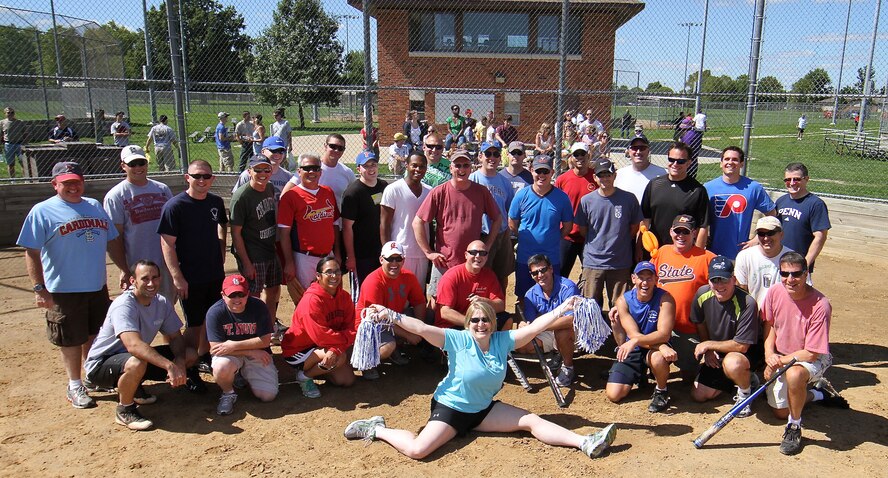 Members of both teams pose after another hard-fought seven-inning game also known as the 932nd Airlift wing  "softball classic"  pitting the O's versus the E's.  The E's prevailed, 21-8.   The game is the highlight of the wing's annual Family Day Picnic held each summer for reservists and their families. (U.S. Air Force photo/Tech. Sgt. Christopher Parr) 