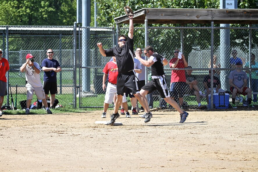 First baseman Nick Vazzana of the "O" team stretches high for a throw in the annual 932nd Airlift Wing's "O's vs. E's" softball classic.  On the play, Ryan Knight was called out at first.  Nevertheless, the E's dominated and won the game, 21-8.  The softball game is the highlight of the Wing's Family Day Picnic held each summer. (U.S. Air Force photo/Tech. Sgt. Christopher Parr)