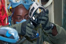 WESTOVER AIR RESERVE BASE, Mass. -- U.S. Air Force Tech. Sgt. Daryl Harper, 439th Aeromedical Evacuation Squadron aeromedical evacuation technician, dons a headset during a simulated aircraft emergency during a quarterly readiness mission at Westover Air Reserve Base, Mass., Aug. 11, 2012. (U.S. Air Force photo/Staff Sgt. Megan Tomkins)