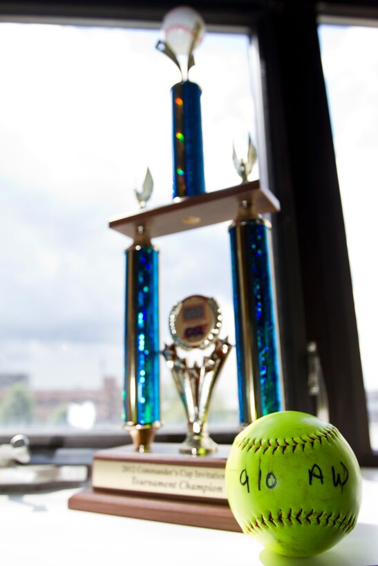 YOUNGSTOWN AIR RESERVE STATION, Ohio -- The USO of Northern Ohio's Commander's Cup and championship-winning game ball are on display in the headquarters building here. U.S. Air Force Reserve Col. Reinhard Schmidt, commander of the 910th Airlift Wing, was presented the trophy by members of the 910th AW Air Force Falcons softball team Sept. 8, 2012 during a wing-wide commander's call here. Service members and civilians from YARS comprise the team and they have won this trophy three consecutive years. U.S. Air Force photo by Tech. Sgt. Brenda Haines/Released