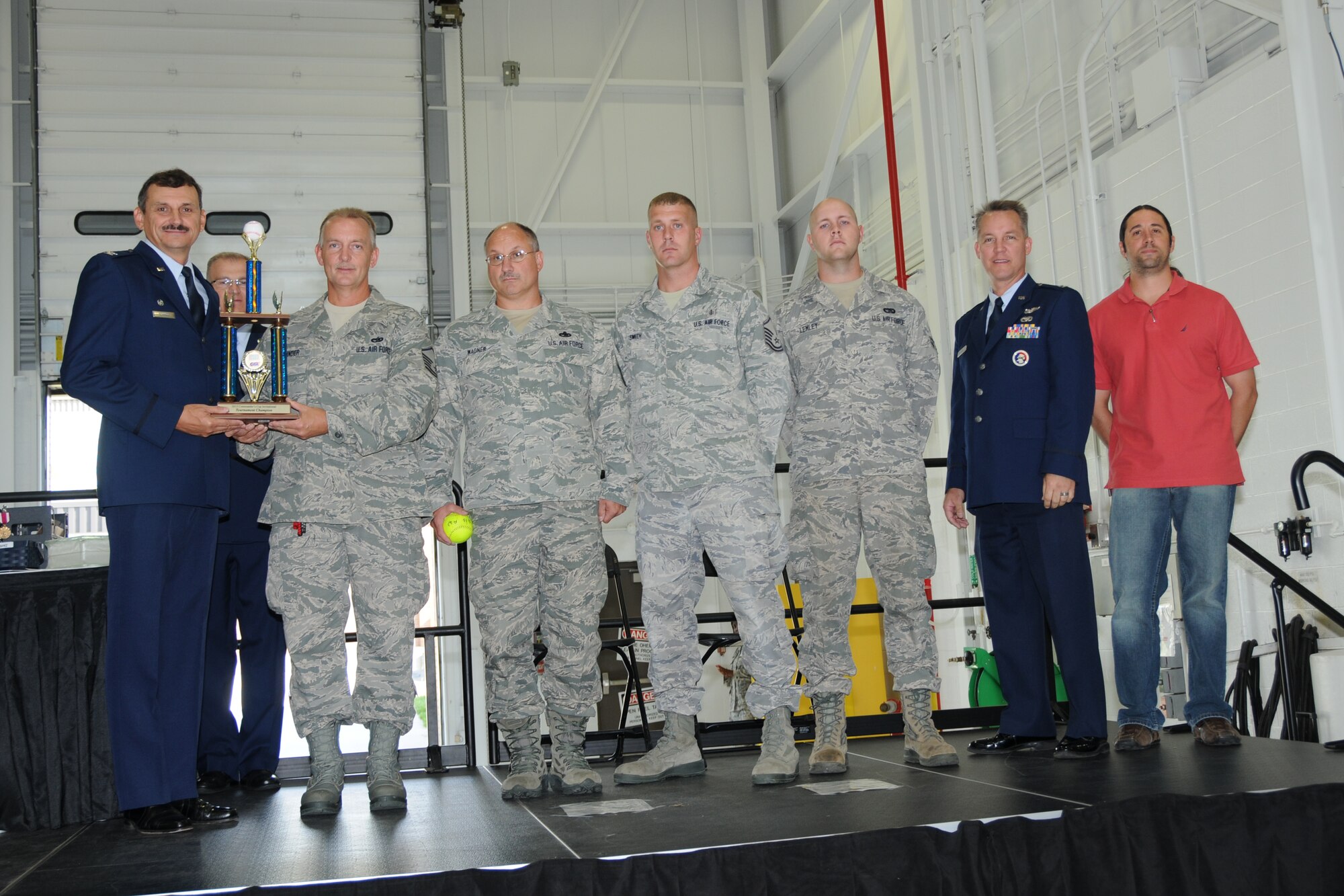 YOUNGSTOWN AIR RESERVE STATION, Ohio -- U.S. Air Force Reserve Col. Reinhard Schmidt, commander of the 910th Airlift Wing, poses with members of the 910th AW Air Force Falcons softball team Sept. 8, 2012 during a wing-wide commander's call here where he received the USO of Northern Ohio's Commander's Cup. Service members and civilians from YARS comprise the team and they have won this trophy three consecutive years. U.S. Air Force photo by Tech. Sgt. Rick Lisum/Released