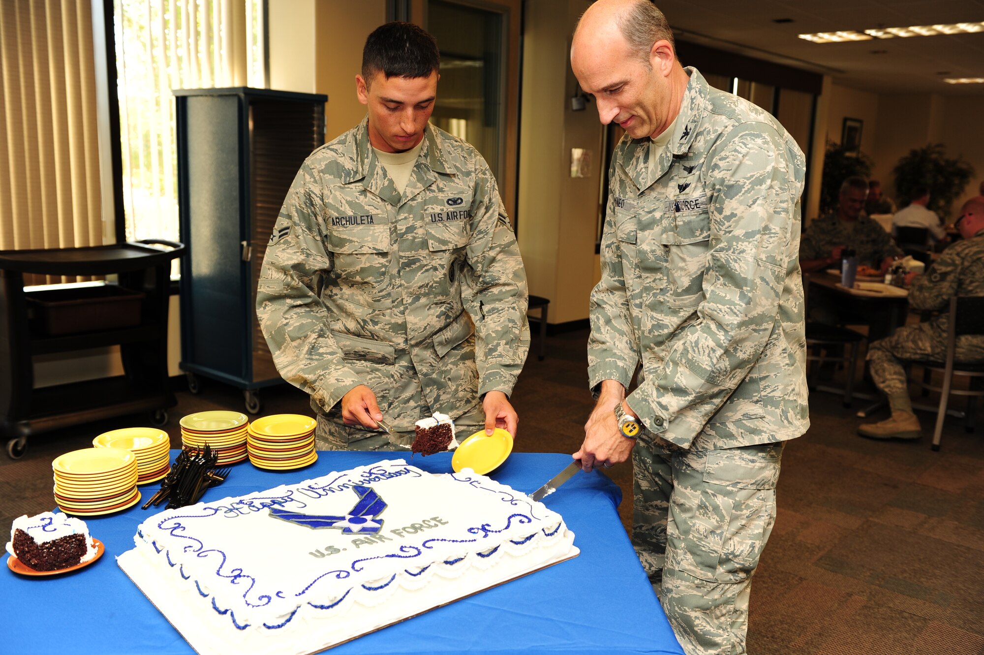 U.S. Air Force Col. Jeffrey T. Mineo and U.S. Air Force Airman 1st Class Abram Archuleta, the youngest Airman in the 310th Space Wing, celebrate the Air Force's birthday, as well as the anniversaries of Air Force Space Command and the 310th Space Wing, with a cake cutting ceremony on Schriever Air Force Base, Colo., Sept. 8. (U.S. Air Force photo by Tech. Sgt. Nicholas B. Ontiveros/Released)