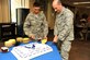 U.S. Air Force Col. Jeffrey T. Mineo and U.S. Air Force Airman 1st Class Abram Archuleta, the youngest Airman in the 310th Space Wing, celebrate the Air Force's birthday, as well as the anniversaries of Air Force Space Command and the 310th Space Wing, with a cake cutting ceremony on Schriever Air Force Base, Colo., Sept. 8. (U.S. Air Force photo by Tech. Sgt. Nicholas B. Ontiveros/Released)