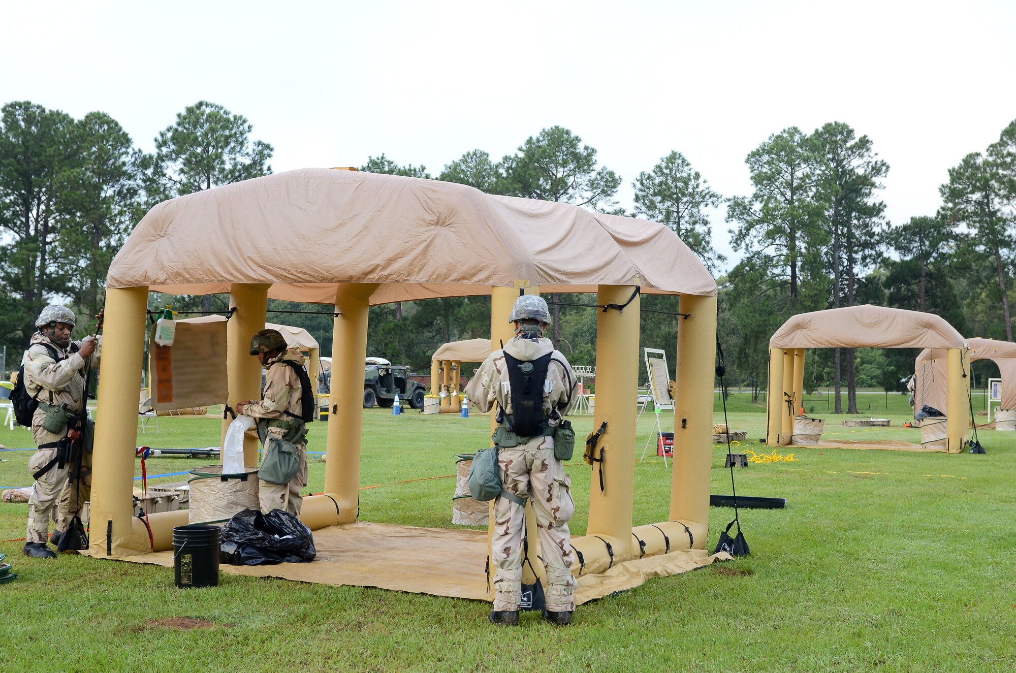 U.S. Air Force Airmen from Team Joint STARS 116th and 461st Air Control Wings set up a contamination control area (CCA) during an operational readiness inspection at Robins Air Force Base, Ga., Sept. 6, 2012.  The CCA was used to decontaminate simulated victims of chemical or biological attacks during the inspection. Portions of this image have been blurred for security reasons. (National Guard photo by Master Sgt. Roger Parsons/Released)
