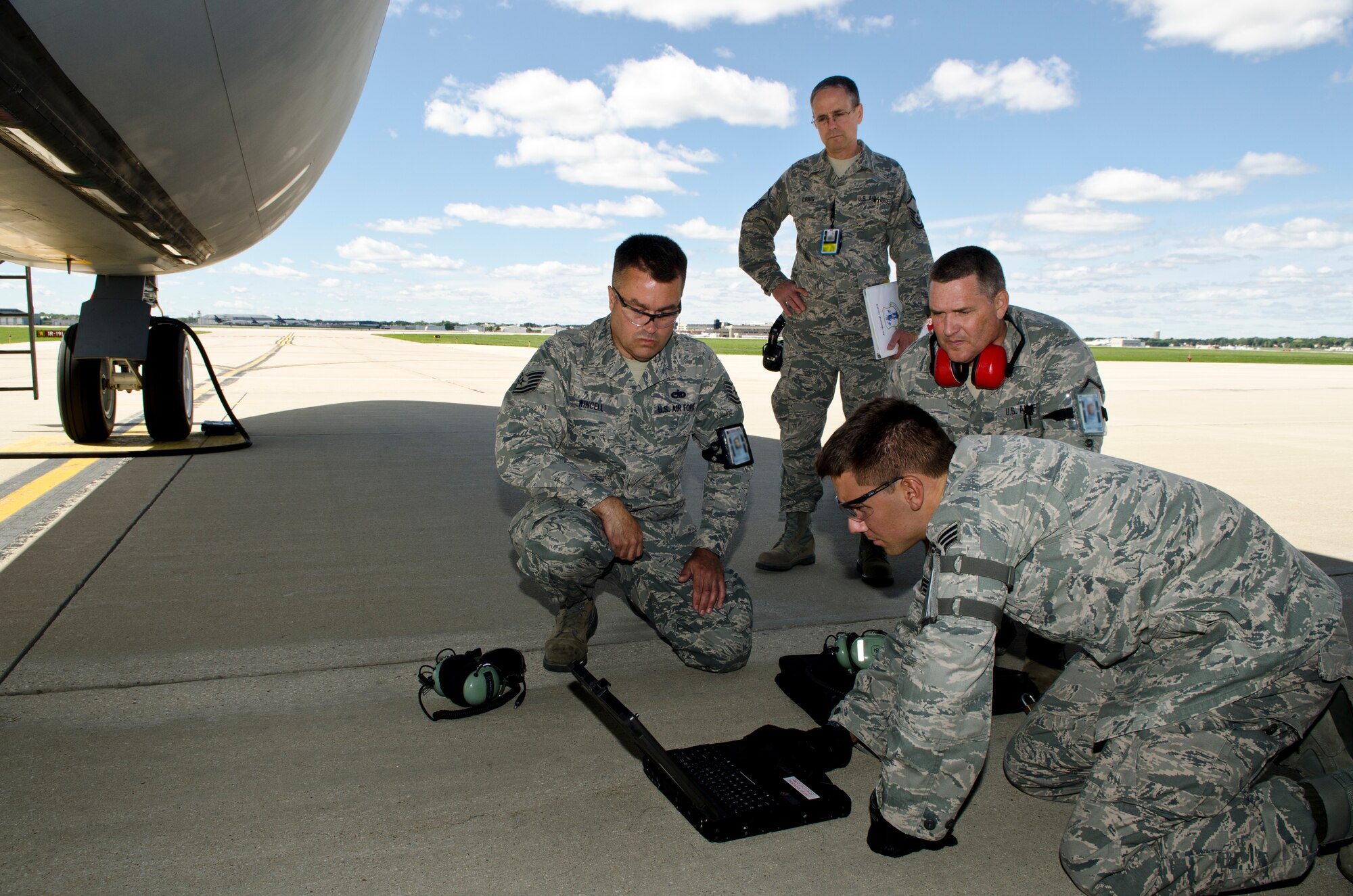 Members of the 128th Air Refueling Wing's Maintenance Squadron reference
their technical orders for a KC-135 Stratotanker while an Air Force
Inspector evaluates them during a Compliance Inspection at the 128 ARW,
Milwaukee, Sept. 8, 2012. From left, Tech. Sgt David Wincell, Senior Airman
Justin Henrichs, and Master Sgt Thomas Proctor worked to complete a task assigned and evaluated by the Air Force Inspector to check the compliance with Air Force tasks, procedures, and protocols. (Air National Guard Photo by Tech. Sgt Thomas Sobczyk / Released)
