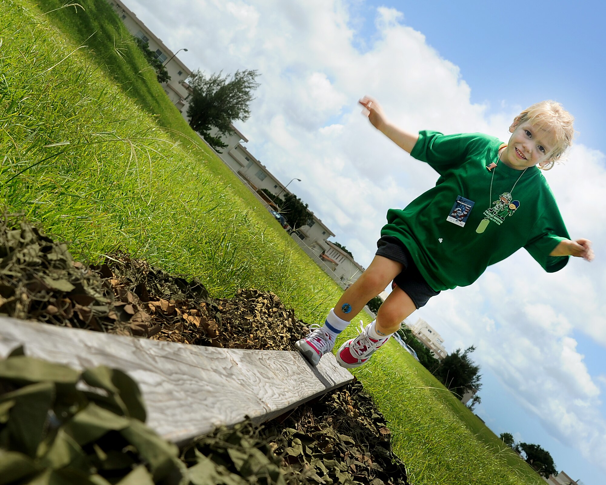 Kaylie Babocsi runs across a plank during the obstacle course portion of Skoshi Warrior on Kadena Air Base, Japan, Sept. 8, 2012. The annual event aimed to help military children better understand what their parents go though while deploying and get face time with various base support agencies. (U.S. Air Force photo/Staff Sgt. Laszlo Babocsi)