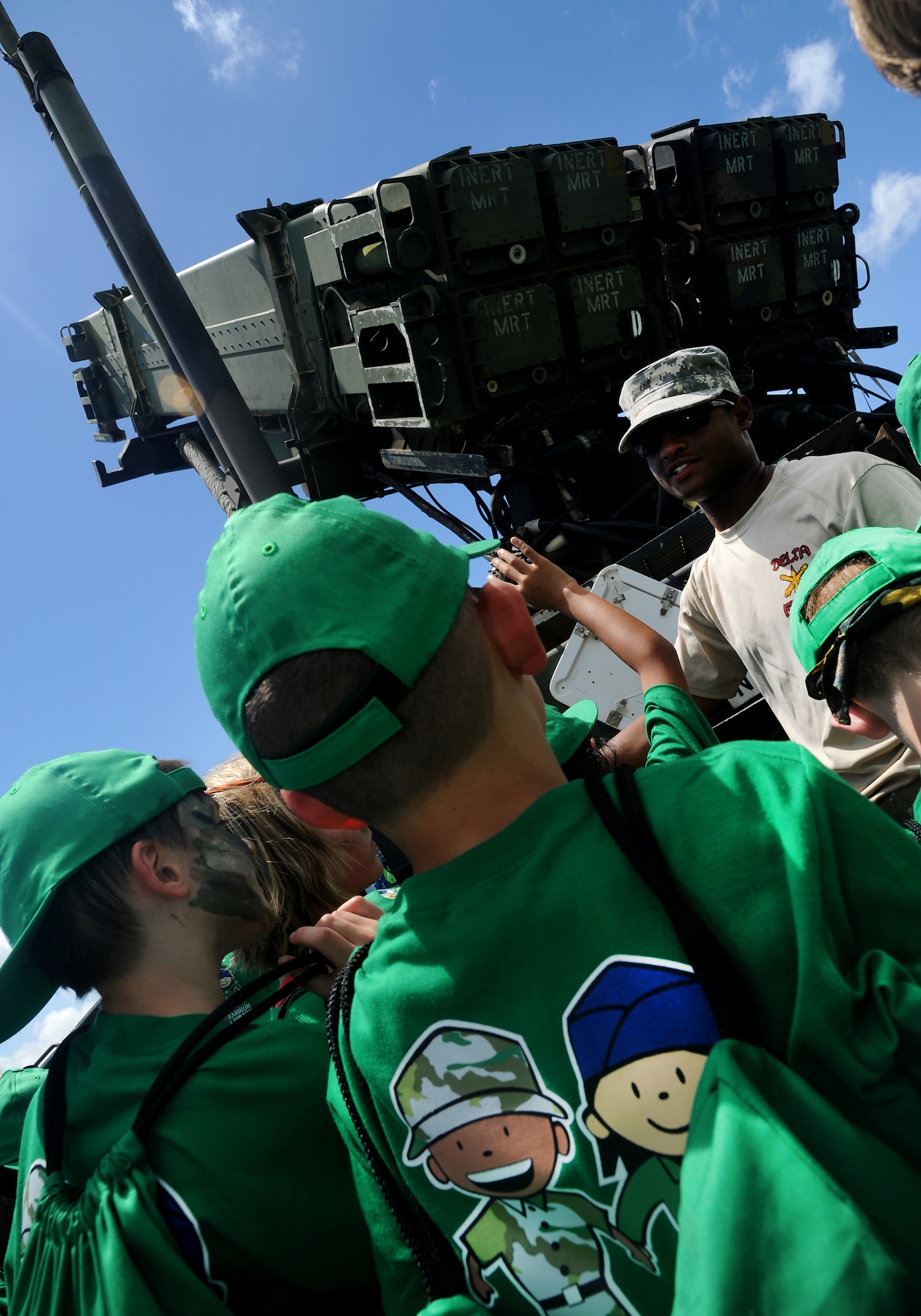 Pvt. Hassen James, 11th Air Defense Artillery Battalion, talks about the equipment his battalion operates to children attending Skoshi Warrior on Kadena Air Base, Sept. 8, 2012. Nearly 300 children participated in the annual event aimed at helping military children understand what their parents go though while deploying. (U.S. Air Force photo/Staff Sgt. Laszlo Babocsi)