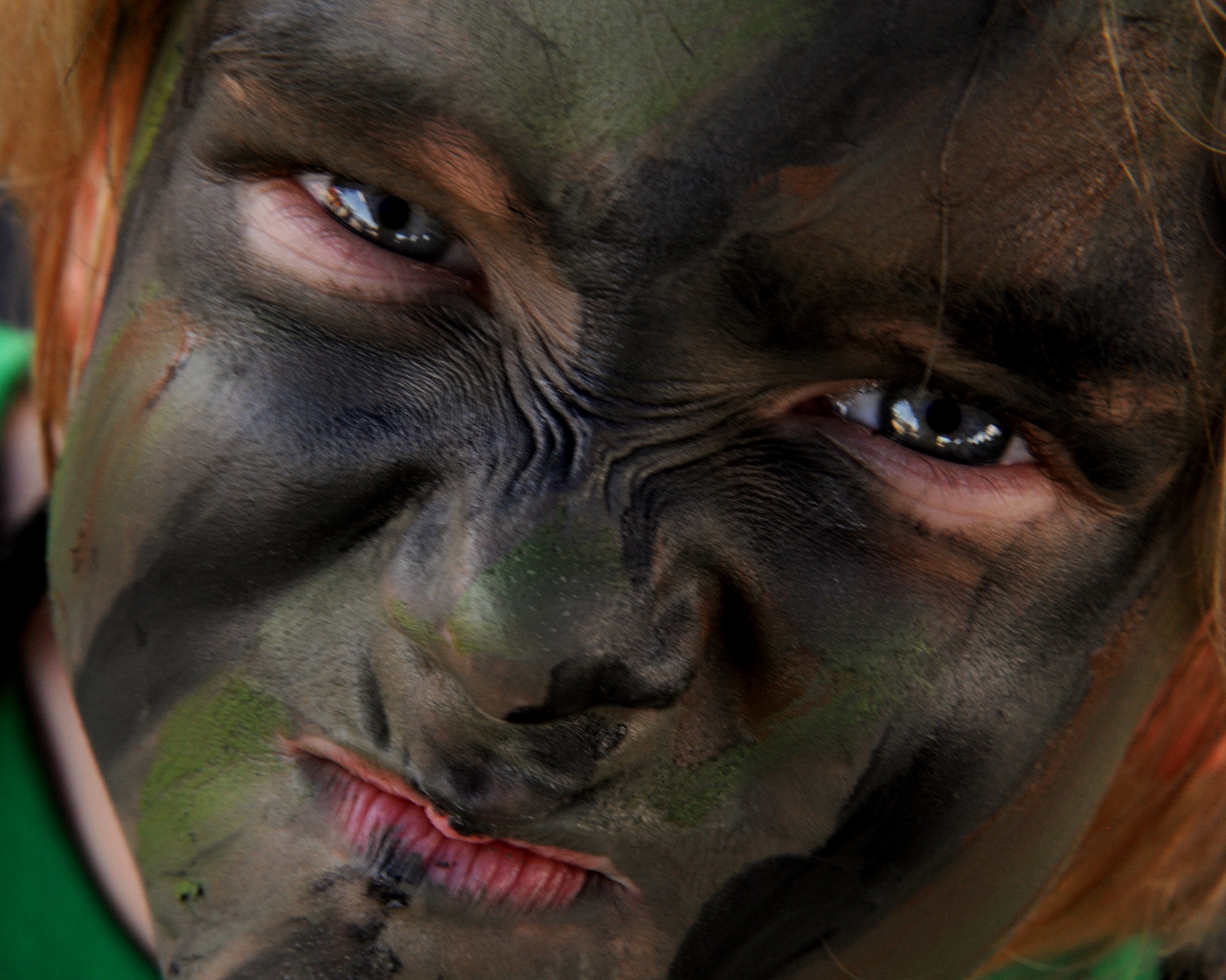 Brynn Babocsi makes a "warrior" face after getting her face painted at the Skoshi Warrior on Kadena Air Base, Japan, Sept. 8, 2012. This event is to help military children better understand what their parents go though while deploying by giving them a hands-on experience at some of the tasks military members go though. (U.S. Air Force photo/Staff Sgt. Laszlo Babocsi)