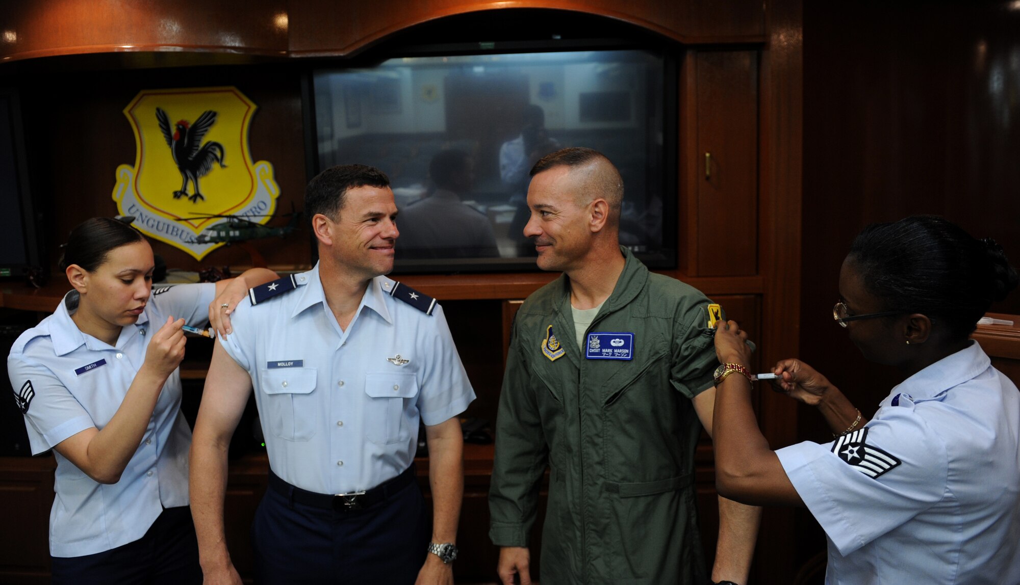 U.S. Air Force Brig. Gen. Matt Molloy, 18th Wing commander, and Chief Master Sgt. Mark Marson, 18th Wing command chief, gets their influenza shots at the 18th Wing headquarters building on Kadena Air Base, Japan, Sept. 10, 2012. Active duty service members can get their annual flu shot at the 18th Medical Group clinic's aeromedical staging facility on Tuesdays and Fridays from 1-3 p.m. throughout September. Call immunizations at 630-4415 for more information. (U.S. Air Force photo/Airman 1st Class Justin Veazie) 