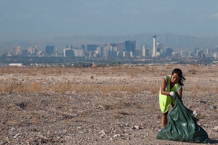 U.S. Air Force Airman 1st Class Marnie Mulingbayan, 99th Medical Support Squadron medical service technician, cleans the side of East El Campo Grande Avenue  Sept. 9 2012, in Las Vegas. Fifty-eight Airmen from Nellis Air Force Base volunteered to assist the city of North Las Vegas with a cleanup effort that resulted in 40 tons of debris being removed from local streets in the area.(U.S. Air Force photo by Staff Sgt. Christopher Hubenthal)