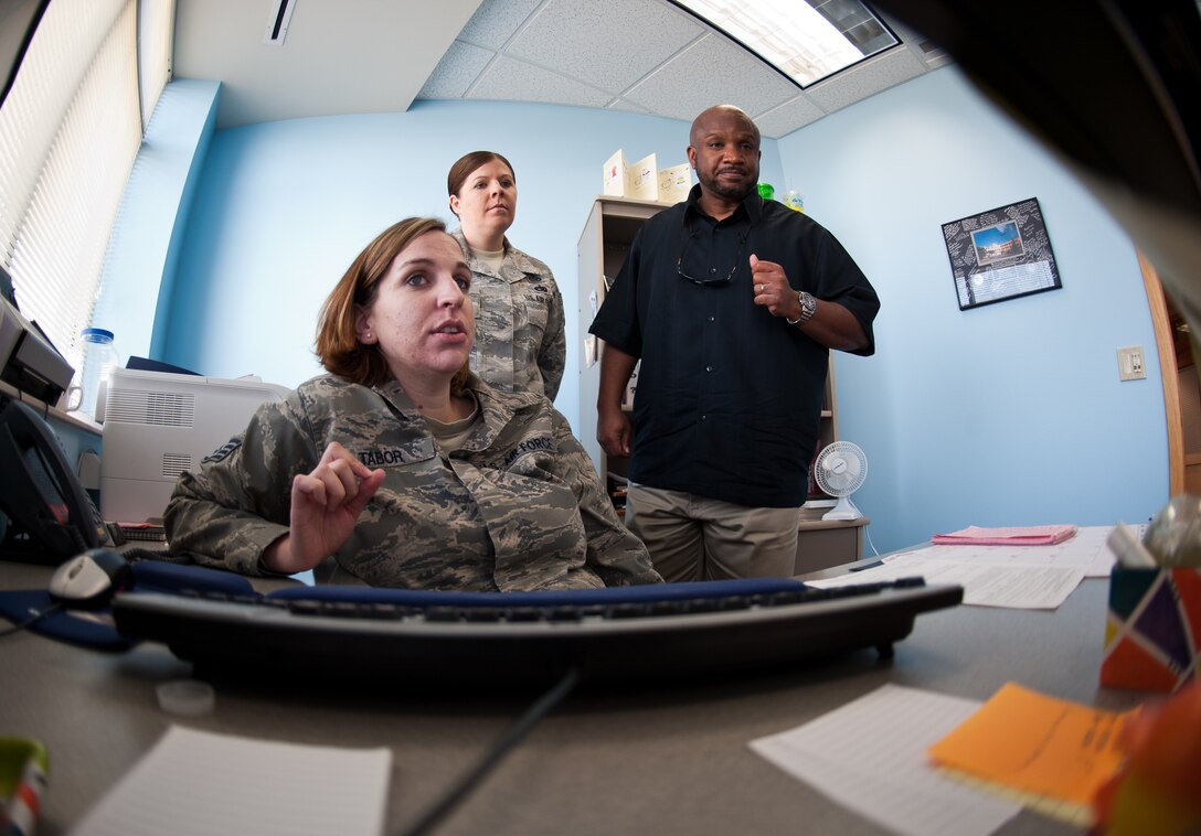 Staff Sgt. Jessica Tabor, 28th Bomb Wing equal opportunity advisor, discusses an email with Tech. Sgt. Candice Compton, 28th Bomb Wing EO advisor, and Donald Bell, 28th Bomb Wing EO director, at Ellsworth Air Force Base, S.D., Sept. 6, 2012. The 28th BW EO office is responsible for providing Airmen with education and recourses to keep their work centers free of sexual harassment and unlawful discrimination. (U.S. Air Force photo by Airman 1st Class Alystria Maurer/Released)